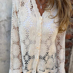 White lace cardigan with V-neck, three-button placket, and long openwork sleeves