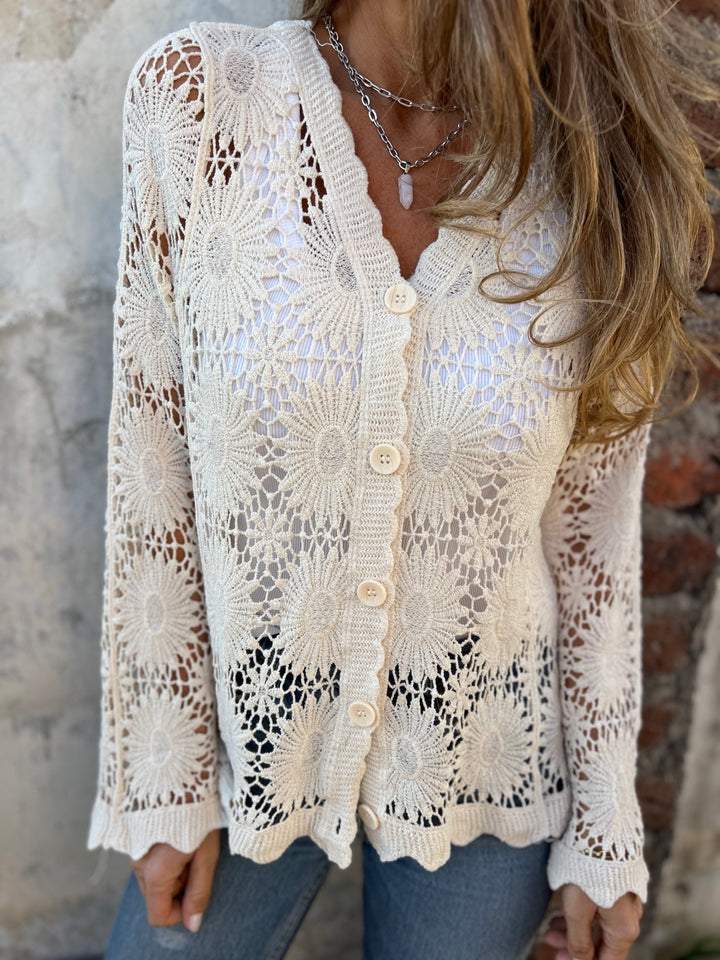 White lace cardigan with V-neck, three-button placket, and long openwork sleeves