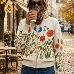 Floral knit cardigan with full zip and ribbed hem, cream with orange, blue, and green blooms