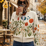 Floral knit cardigan with full zip and ribbed hem, cream with orange, blue, and green blooms