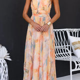 Peach watercolor halter maxi dress with fitted bodice and tie waist
