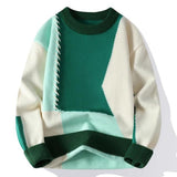Color-block knit sweater with cream base and dark green panel with teal lower section