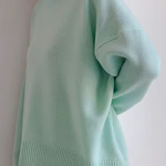Oversized mint green turtleneck knit sweater with ribbed collar and hem