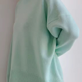 Oversized mint green turtleneck knit sweater with ribbed collar and hem