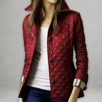 Burgundy quilted fall jacket with button front, stand collar, and side pockets