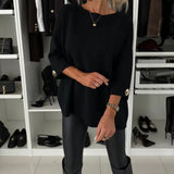 Black knit pullover with round neckline and buttoned sleeve cuffs