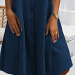 Dark blue denim shirt dress with button front and flared hem, knee-length