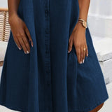 Dark blue denim shirt dress with button front and flared hem, knee-length