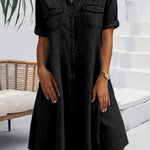 Black denim shirt dress with short sleeves, button front, and chest pockets