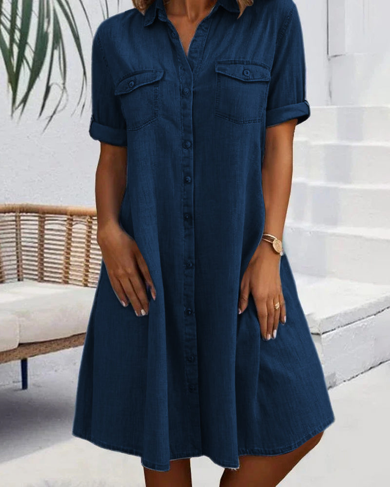 Navy denim shirt dress with short sleeves, button front, and chest pockets