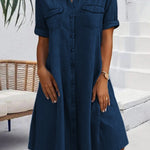 Navy denim shirt dress with short sleeves, button front, and chest pockets