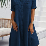Navy denim shirt dress with short sleeves, button front, and chest pockets