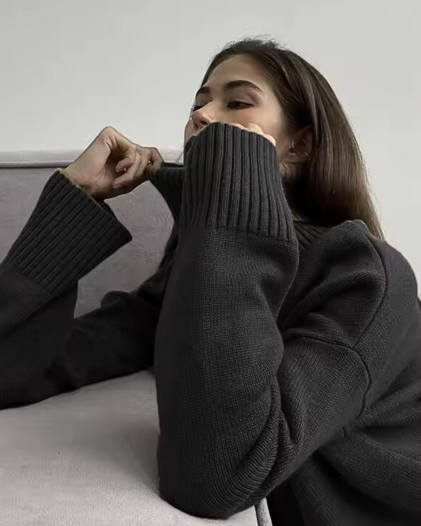 Black ribbed turtleneck sweater with long sleeves and fitted cuffs