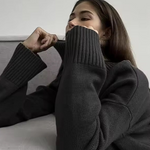 Black ribbed turtleneck sweater with long sleeves and fitted cuffs