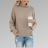 Beige chunky knit sweater with ribbed turtleneck, long sleeves, and straight hem