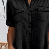 Black denim shirt dress front detail with button placket and chest pockets
