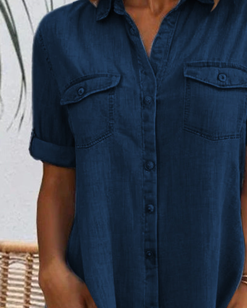 Dark blue denim shirt dress front detail with button placket and chest pockets