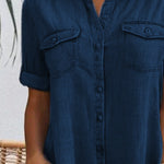 Dark blue denim shirt dress front detail with button placket and chest pockets