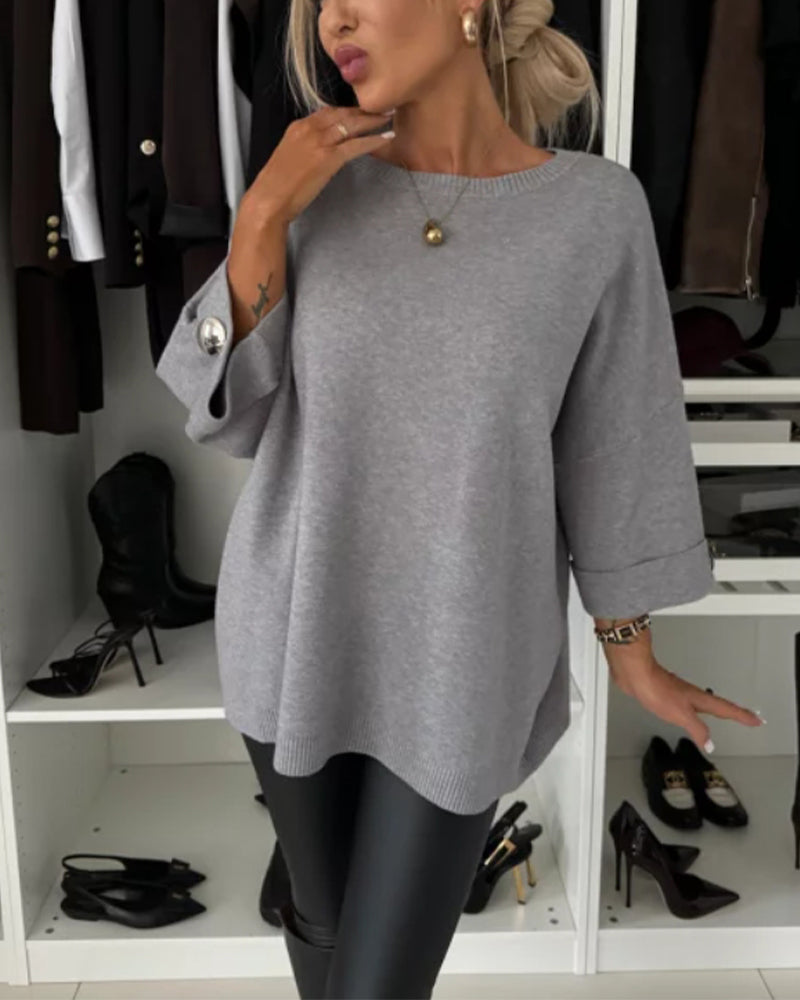Gray knit pullover with wide sleeves and crew neck, ribbed hem