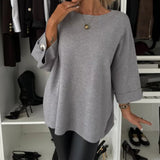 Gray knit pullover with wide sleeves and crew neck, ribbed hem