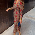 Red patterned midi dress with V-neck, long sleeves, and knotted waist tie