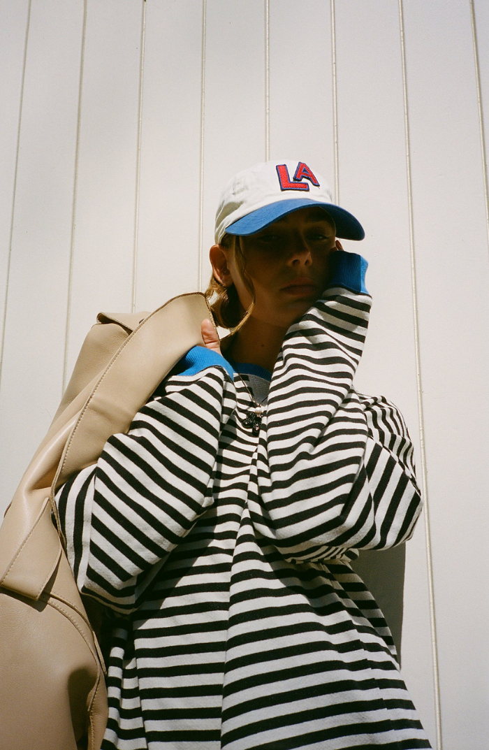 Oversized striped long-sleeve sweater with black and white horizontal stripes and hoodless neckline.