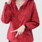 Red hooded jacket with front zipper, ruffled hood edge and leaf-patterned texture