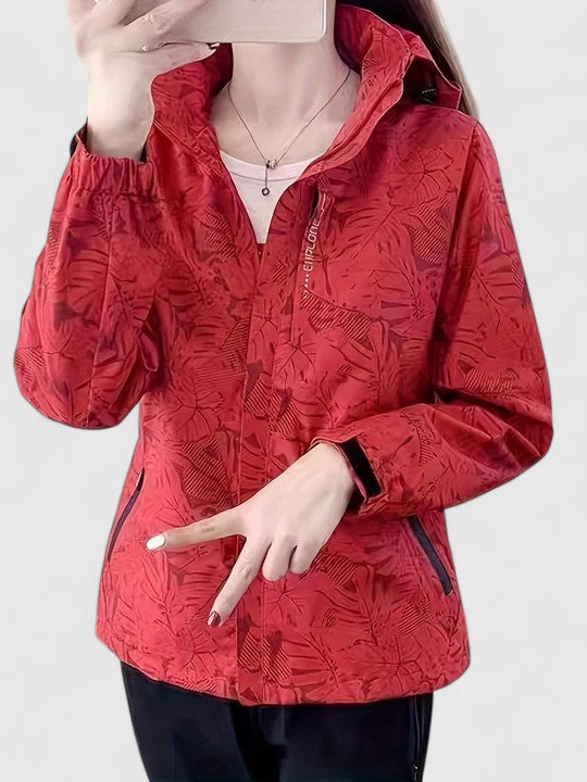 Red hooded jacket with front zipper, ruffled hood edge and leaf-patterned texture