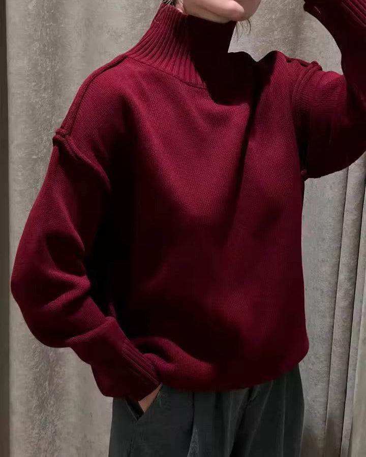 Burgundy knit turtleneck sweater with long sleeves and ribbed collar