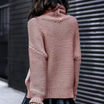 Reddish-pink roll-neck knitted sweater with long sleeves and ribbed cuffs.