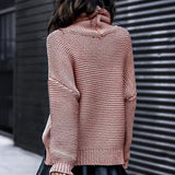 Reddish-pink roll-neck knitted sweater with long sleeves and ribbed cuffs.