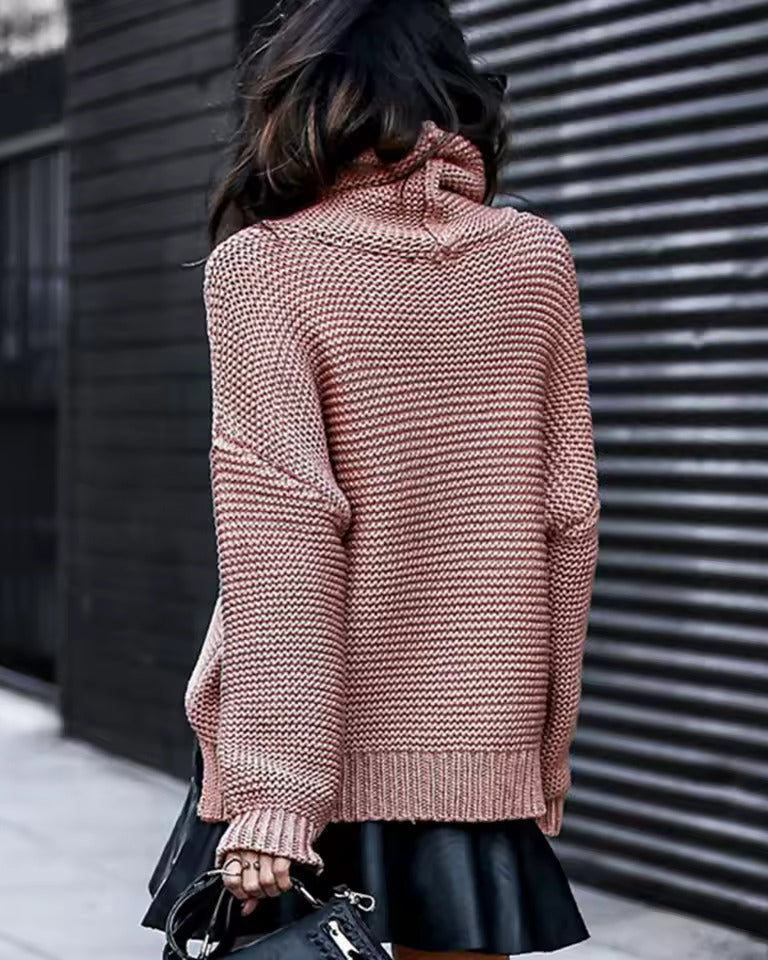 Reddish-pink roll-neck knitted sweater with long sleeves and ribbed cuffs.