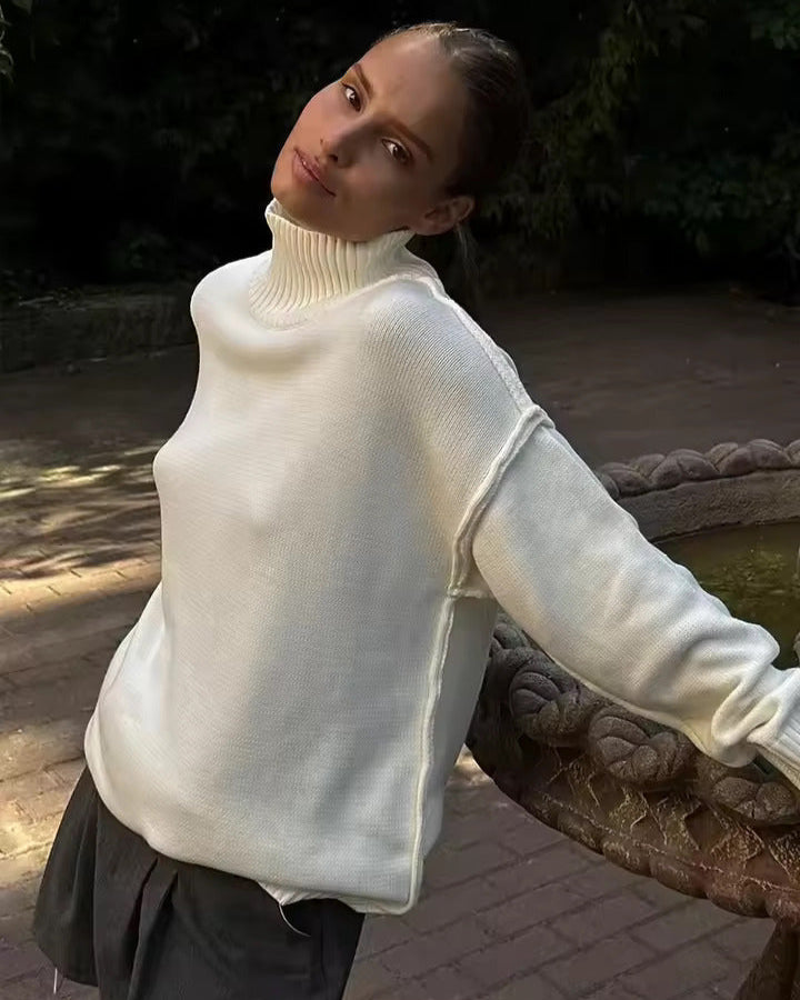 White knit turtleneck sweater with long sleeves and ribbed shoulder detail