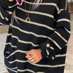 Black knit pullover with wide beige horizontal stripes, long sleeves, buttoned cuff detail.