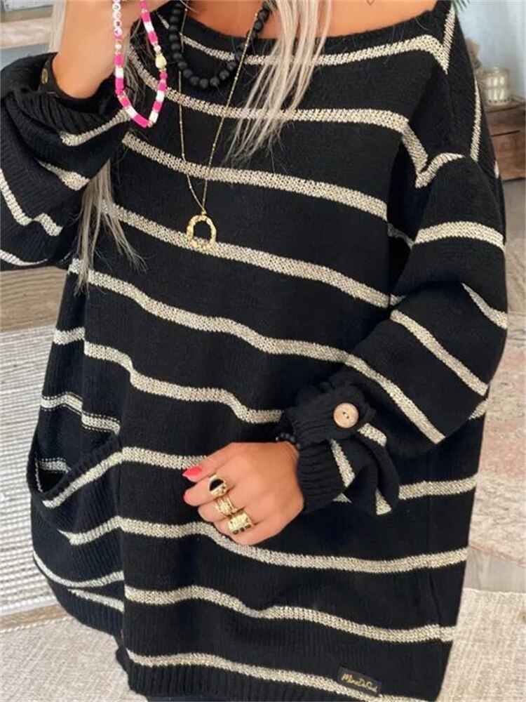 Black striped knit pullover with beige bands, ribbed hem, long sleeves with cuff buttons.
