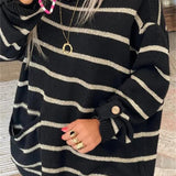 Black striped knit pullover with beige bands, ribbed hem, long sleeves with cuff buttons.