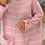 Pink knit pullover with pale yellow stripes, long sleeves, button-detail cuffs and hem.