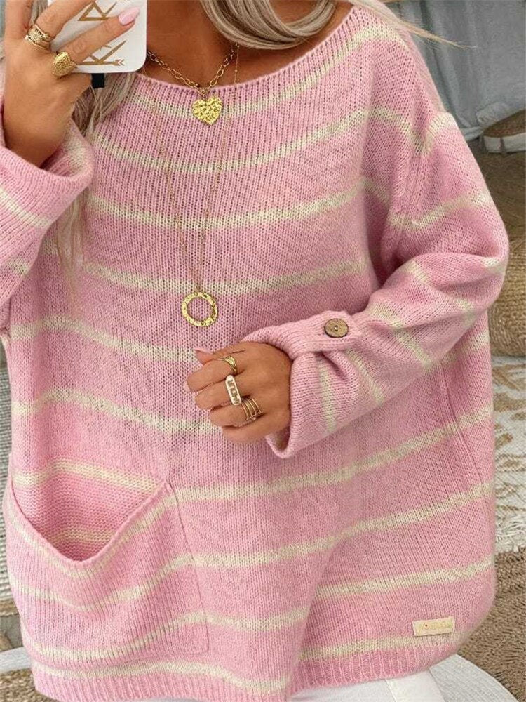 Pink striped knit pullover with round neckline, button-detail cuffs, relaxed long sleeves.