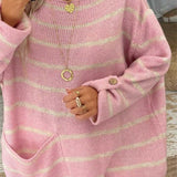 Pink striped knit pullover with round neckline, button-detail cuffs, relaxed long sleeves.