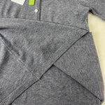 Grey heather knit pullover sleeve and hem with ribbed trim, button placket visible