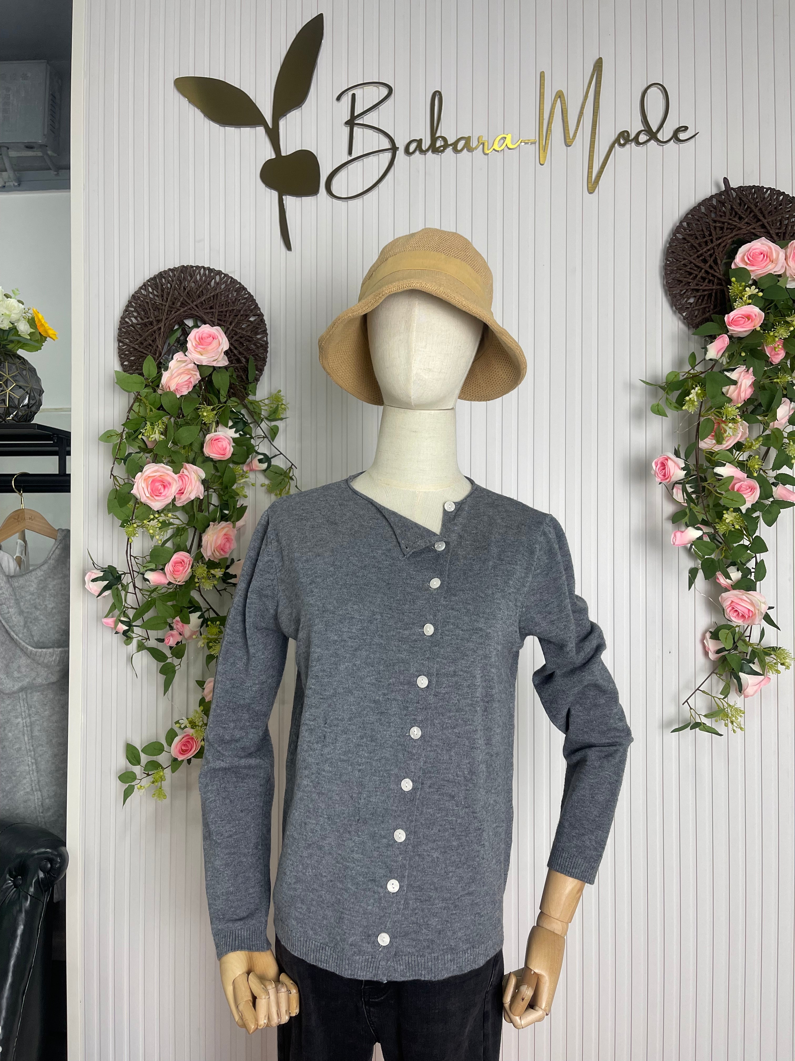 Grey long-sleeve button-front pullover on mannequin with V-neck