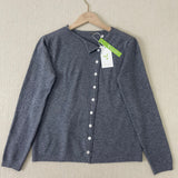 Grey button-front knit pullover with V-neck and long sleeves on hanger
