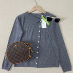Navy-grey button-front knit pullover with V-neck, long sleeves, on hanger