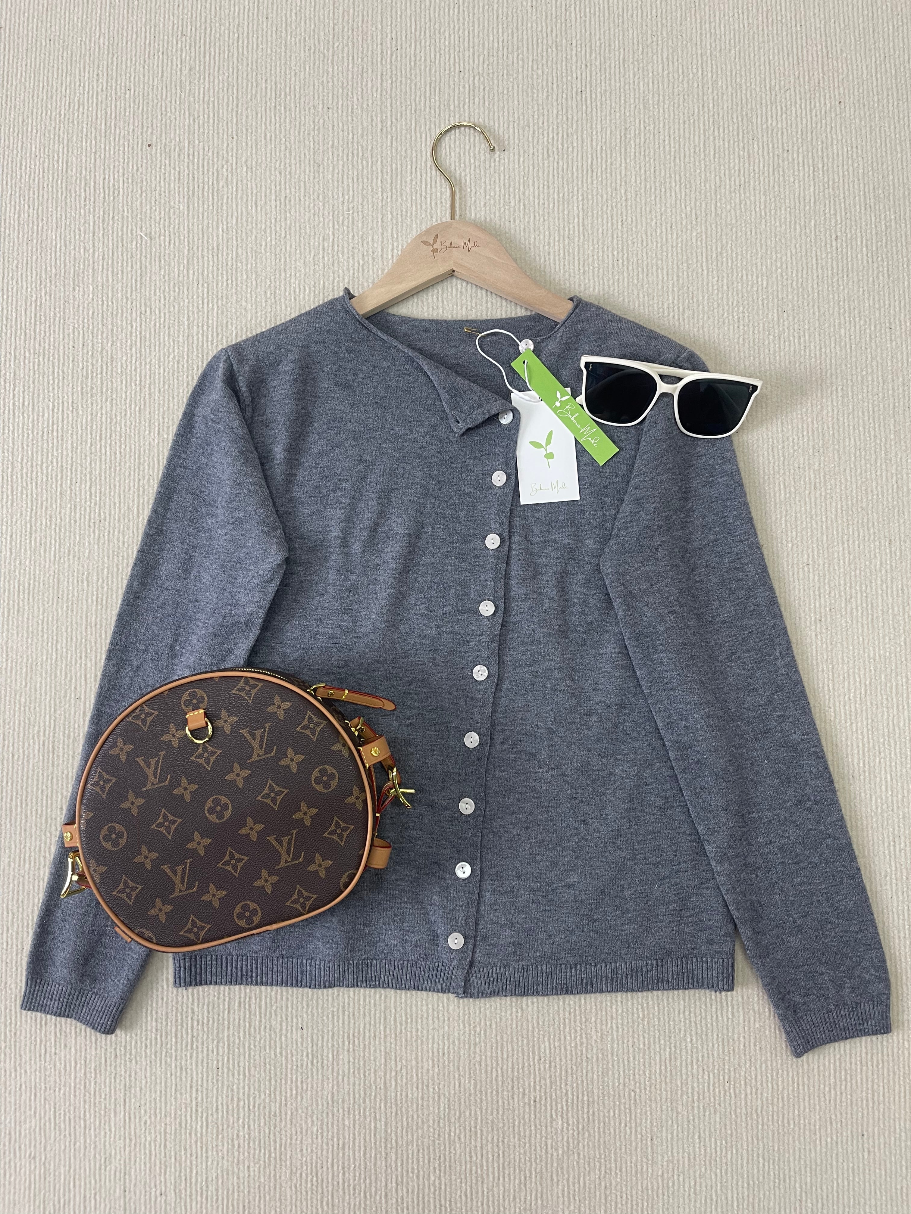 Navy-grey button-front knit pullover with V-neck, long sleeves, on hanger