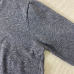 Grey heather knit pullover shoulder and sleeve seam detail