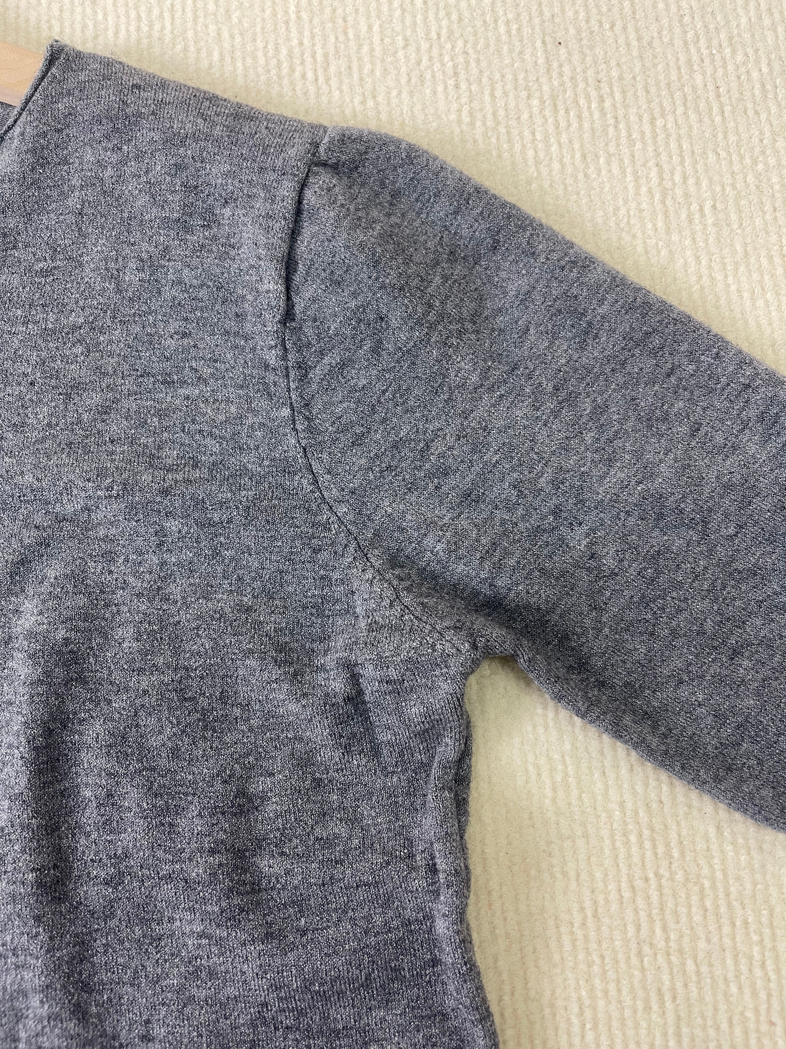 Grey heather knit pullover shoulder and sleeve seam detail