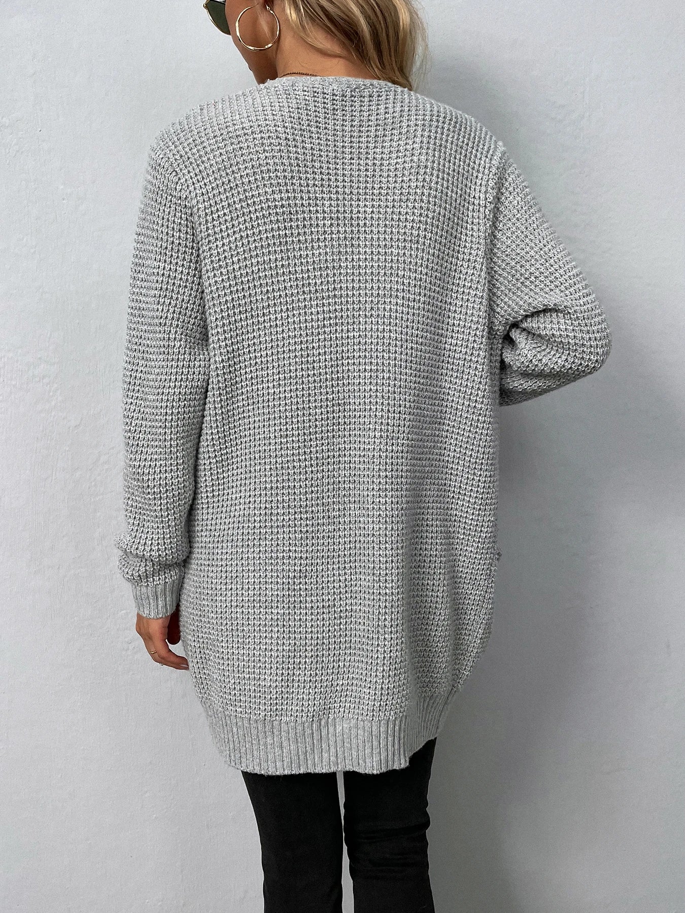 Light gray knit cardigan back view with long sleeves and ribbed hem