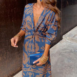 Blue patterned wrap-style midi dress with knotted waist and long sleeves