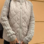 Beige quilted cardigan vest with front zipper and gray knit sleeve cuffs