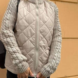 Beige quilted cardigan vest with front zipper and gray knit sleeve cuffs